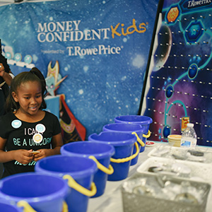 A child plays a game to learn about finance at an T. Rowe Price event.