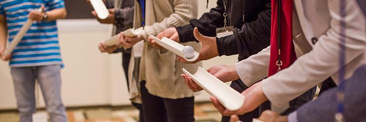 Students participate in an experiment at a T. Rowe Price Career event.