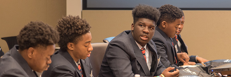 Students listen to a presentation at the Career Day event at T. Rowe Price.