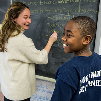 Women writing on chalkboard