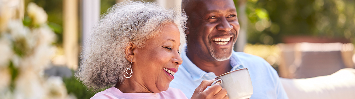 image in article of a couple smiling on couch with coffee cups