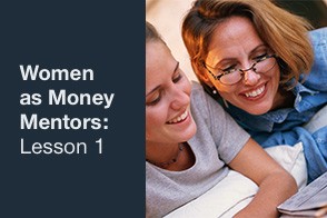 A woman sitting at a table, smiling and mentoring other younger women about financial planning.