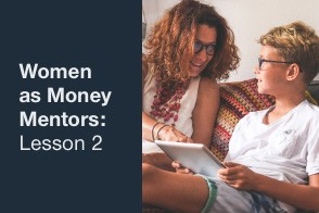 A woman holding a notebook, teaching another woman about setting financial goals.