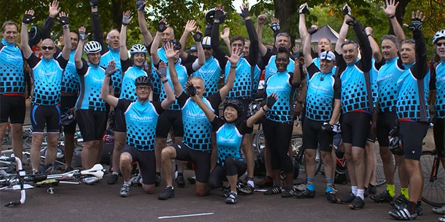 Group photo of London associates in cycling gear.