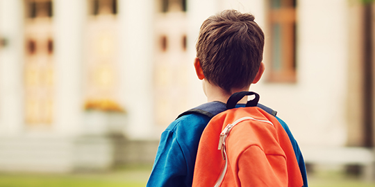 young boy in rucksack
